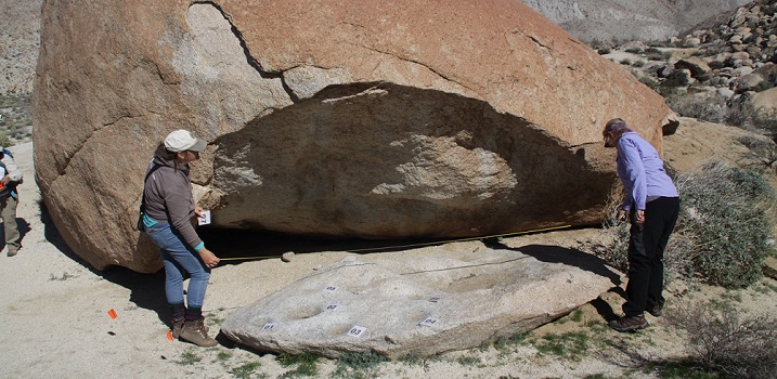 Hayley Elsken, Associate State Archaeologist, and Mary Lou White, Archaeological Volunteer, measure bedrock milling boulder near a rock shelter in the park.