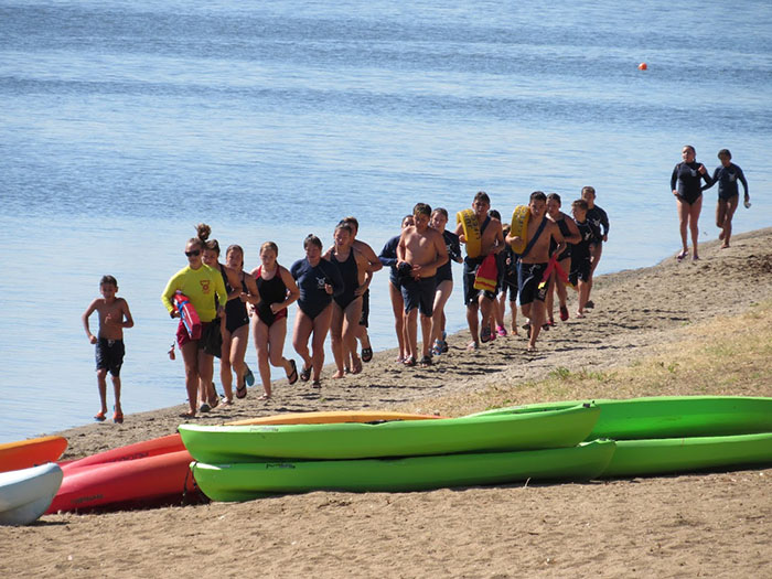 Jr. Guards jogging along the shore