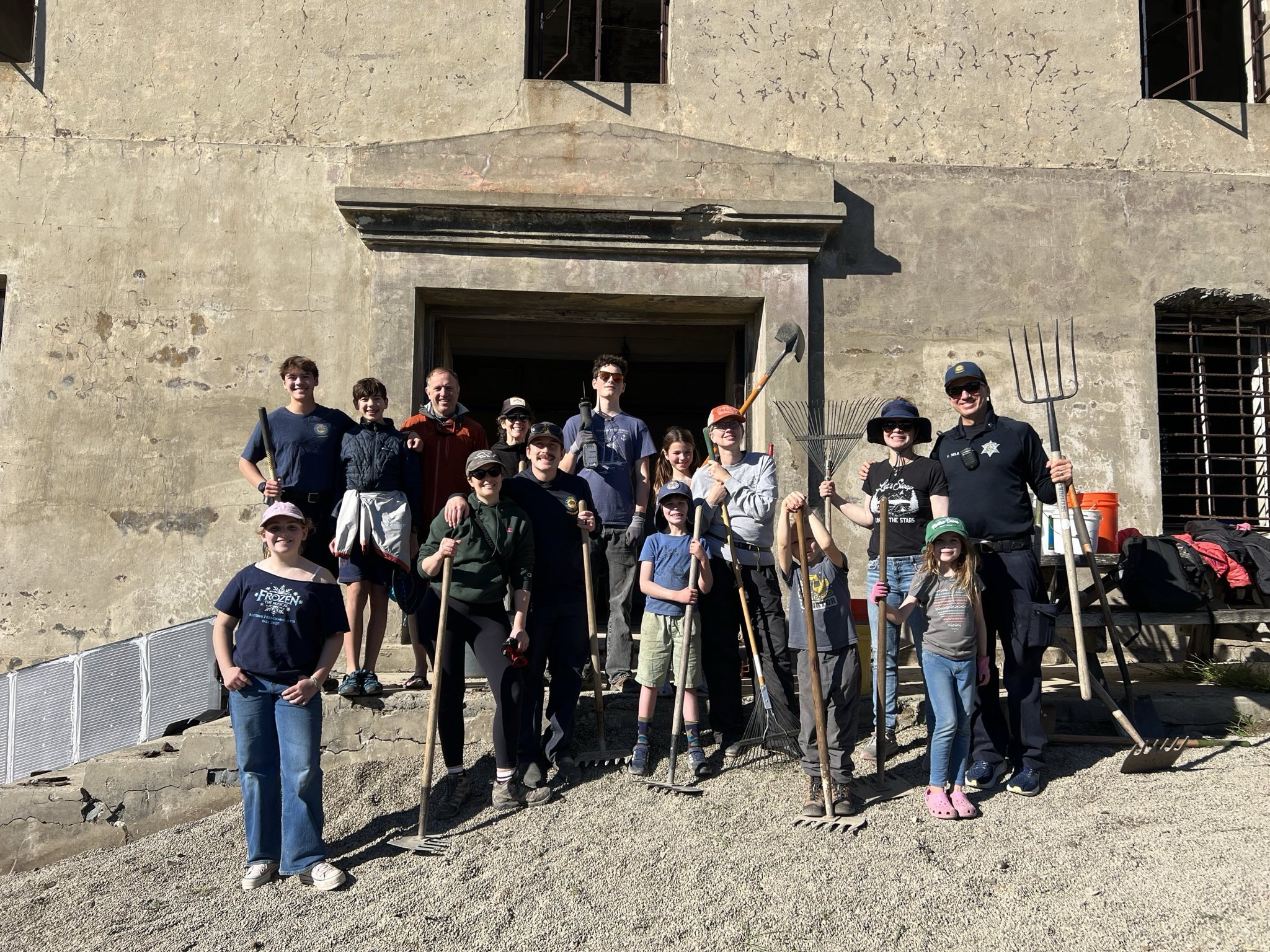 Volunteers posing with hand tools.