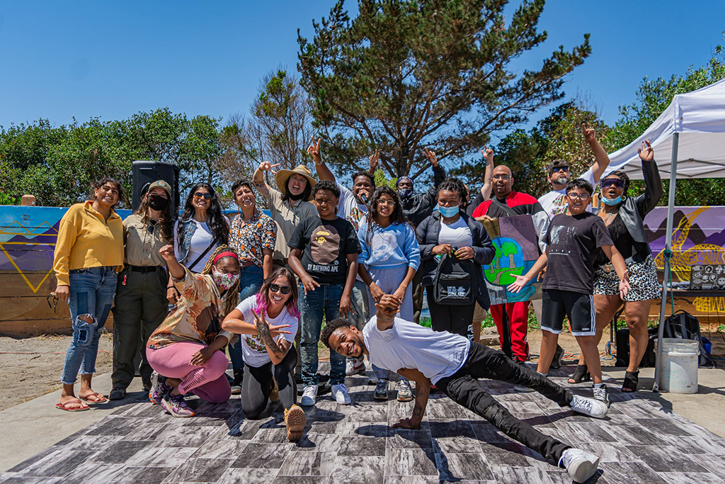 Young people take part in outdoor hip hop activities at a park camp.