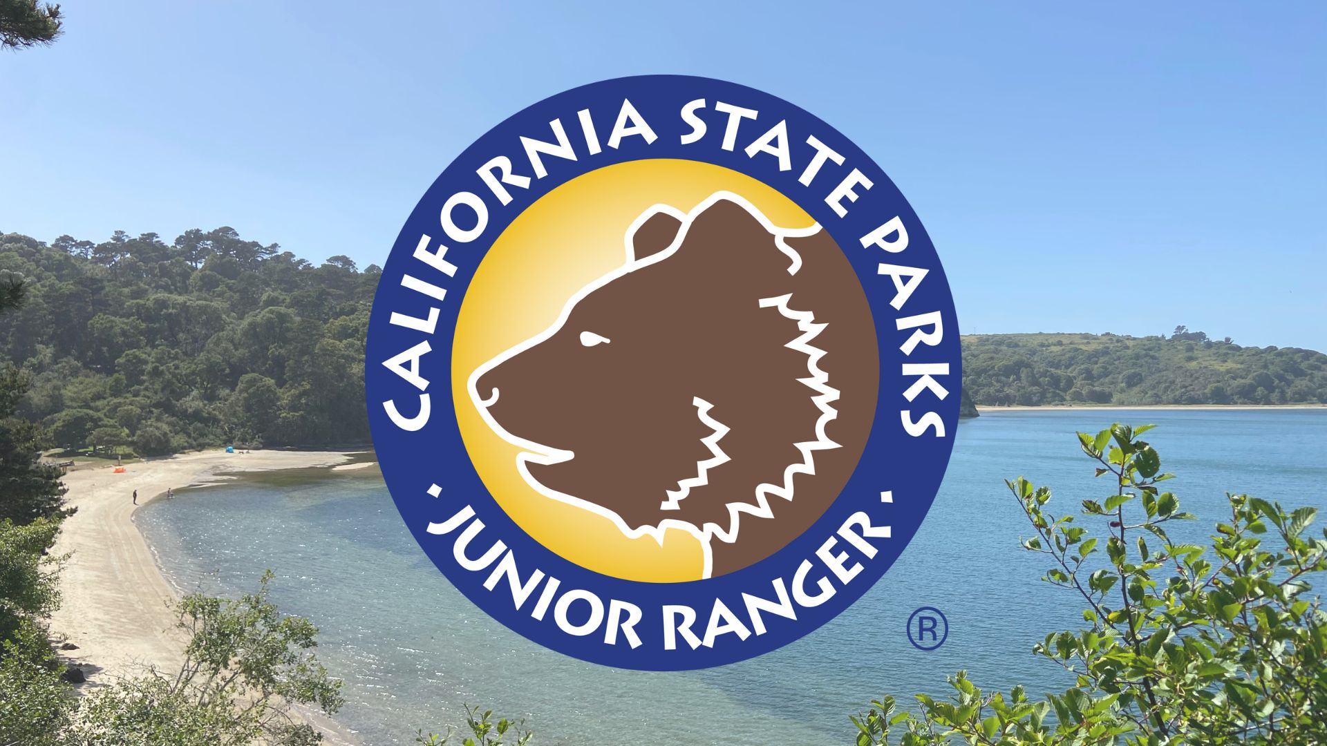 Junior Ranger logo with Heart's Desire Beach in the background.