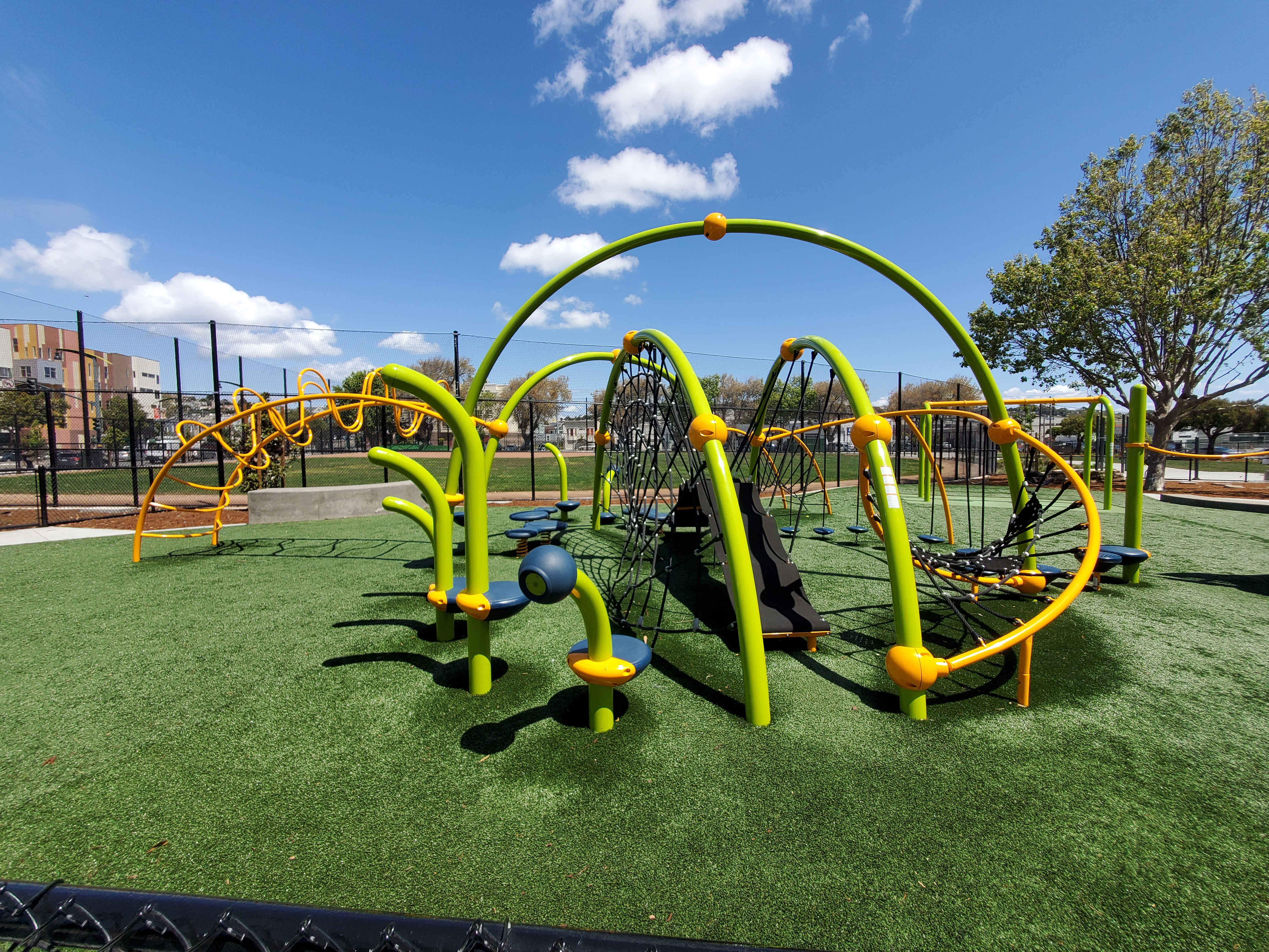 A children's playground equipment on a green playground