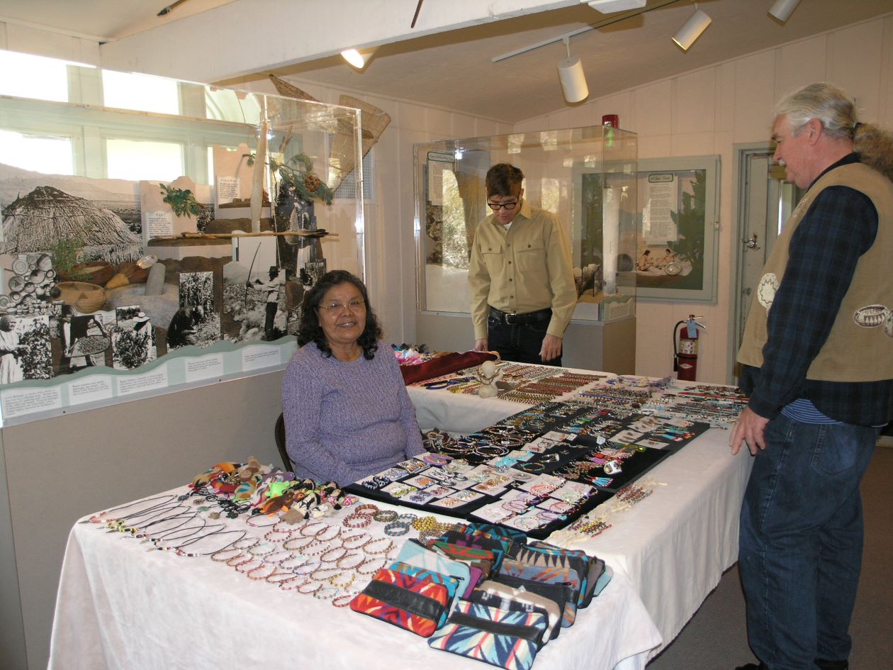 Artist Cecelia Begay shares her art with museum volunteers Darrell Walters and Jim Quinn. Photo from California State Parks.