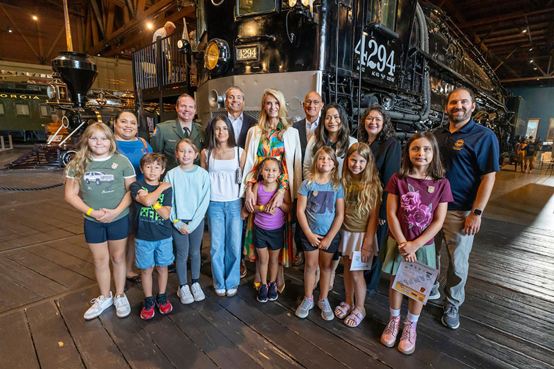 First Partner Jennifer Siebel Newsom, California Natural Resources Secretary Wade Crowfoot, State Parks Director Armando Quintero and Assemblymember Jessica Caloza celebrate with California students during the launch event announcing the newly renamed Free Fourth Grade Pass last month at the California State Railroad Museum in Sacramento. Photo from California State Parks.