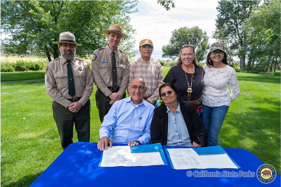 Back row left to Right: California State Parks Northern Division Chief Greg Martin, State Parks Sierra District Superintendent Rich Adams, Tribal Elder Dean Tonenna, Vice Chair Angela Eddy, and Tribal Secretary Barbara Coons. Front row left to right: State Parks Director Armando Quintero and Kootzaduka&rsquo;a Tribal Chair Charlotte Lange.