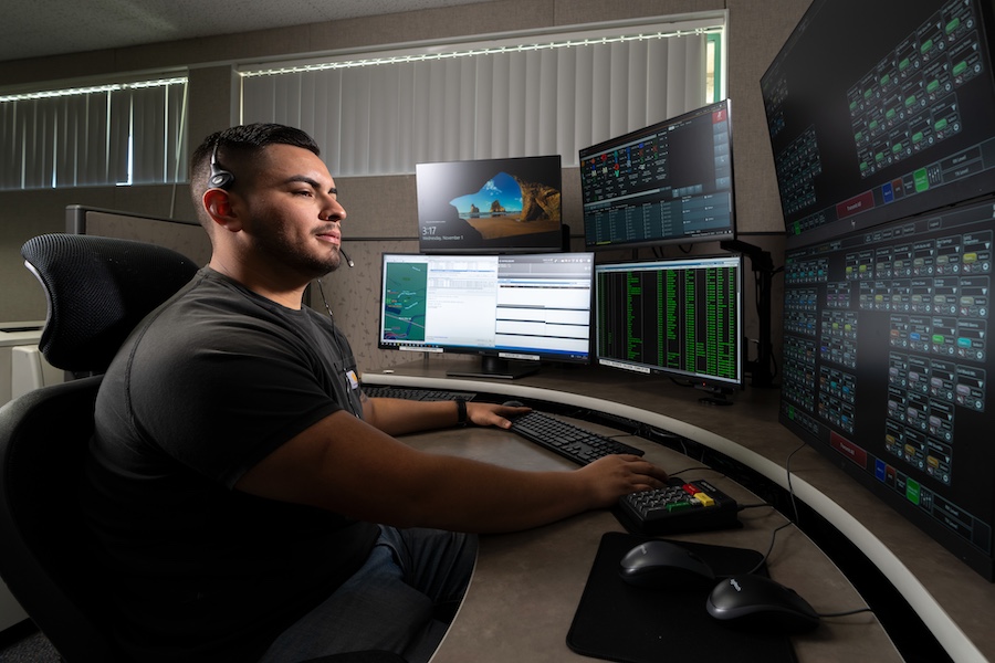 Comm Operator in front of workstation