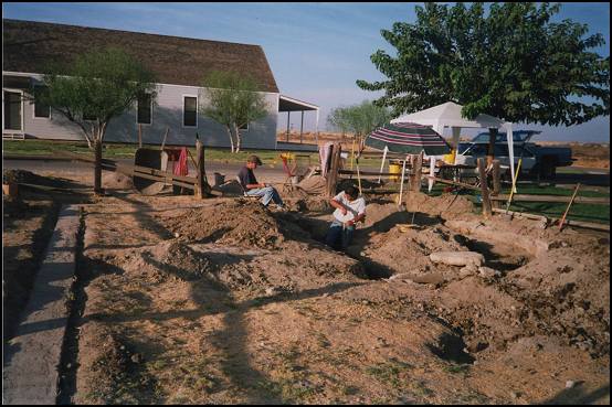 Archeological Project Lead Bruce Steidle (in trench) and State Interpreter II Terri Lopez (taking measurements) obtaining measurements of interior wall.